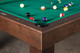 Luxury detail photo of the Paula Parsons Pool Table in Antique Coffee finish with genuine leather drop pocket and green Championship felt. Luxury detail photo of the Paula Parsons Pool Table in Antique Coffee finish with genuine leather drop pocket and green Championship felt.